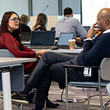 Julia Baranovskaya (NDAX Canada Inc.) and Peter Anaman (Microsoft) discussing disruption strategies.